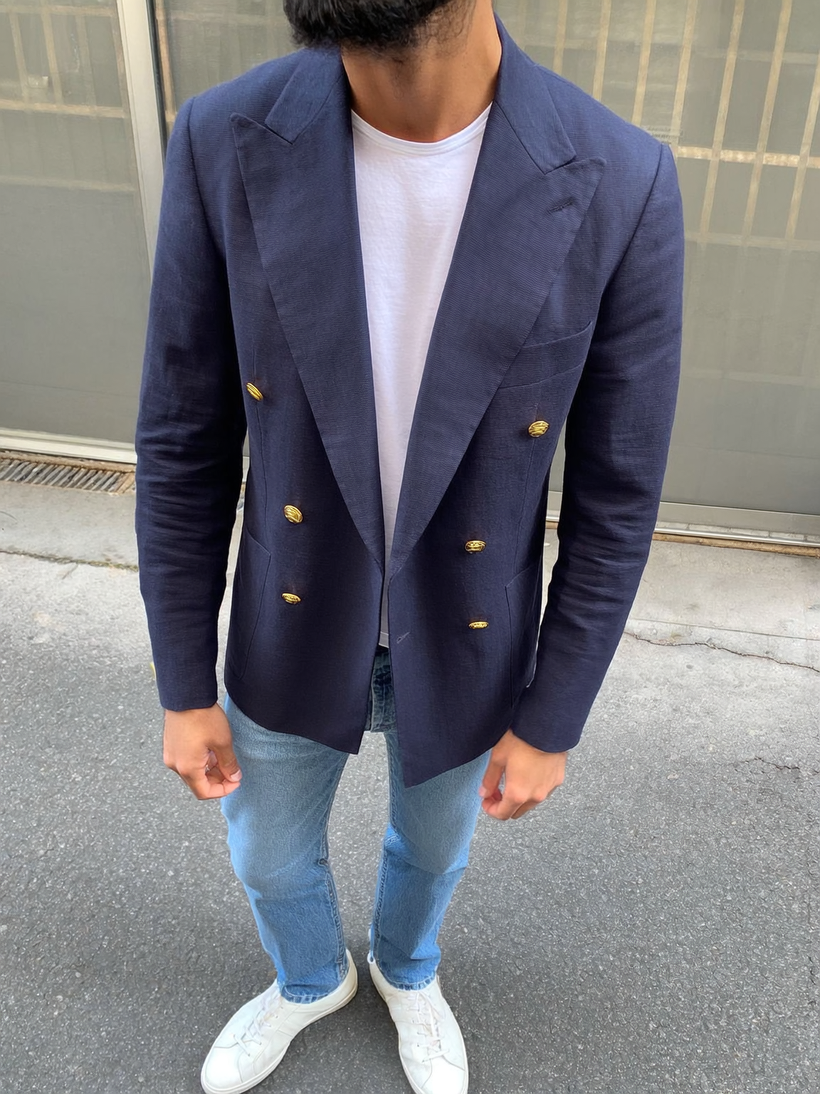 a5a202fd-6e54-4aad-aed7-f5243a6ad01e Classic Double-Breasted Navy Blazer made in a Super 140s Merino Wool styled with a tshirt, light wash jeans and white sneakers