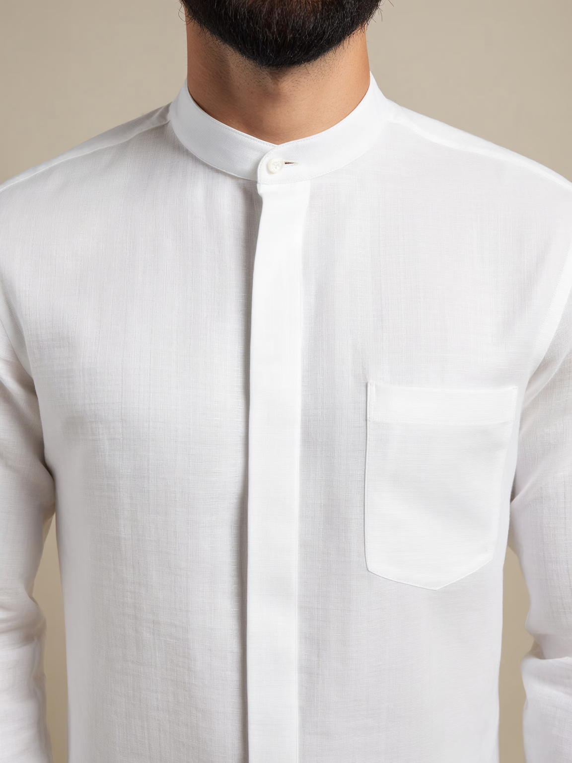 Concealed Placket Close up on Side Pleats on Box pleats on Barrel cuff close up of Classic White Grandaddy Shirt with a Mandarin Collar in a Dobby Weave made with a 100% Cotton Dobby Fabric Concealed Placket Close up on Side Pleats on Box pleats on Barrel cuff close up of Classic White Grandaddy Shirt with a Mandarin Collar in a Dobby Weave made with a 100% Cotton Dobby Fabric